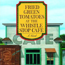 Fried Green Tomatoes at the Whistle Stop Cafe Photo of the cover of Fried Green Tomatoes at the Whistle Stop Cafe: A Novel by Fannie Flagg. The background shows a building, in the style of Normal Rockwell, with Cafe above a window and door. In front of the cafe to the left, is the redish brown back of a railroad car for the Cotton Belt Route.